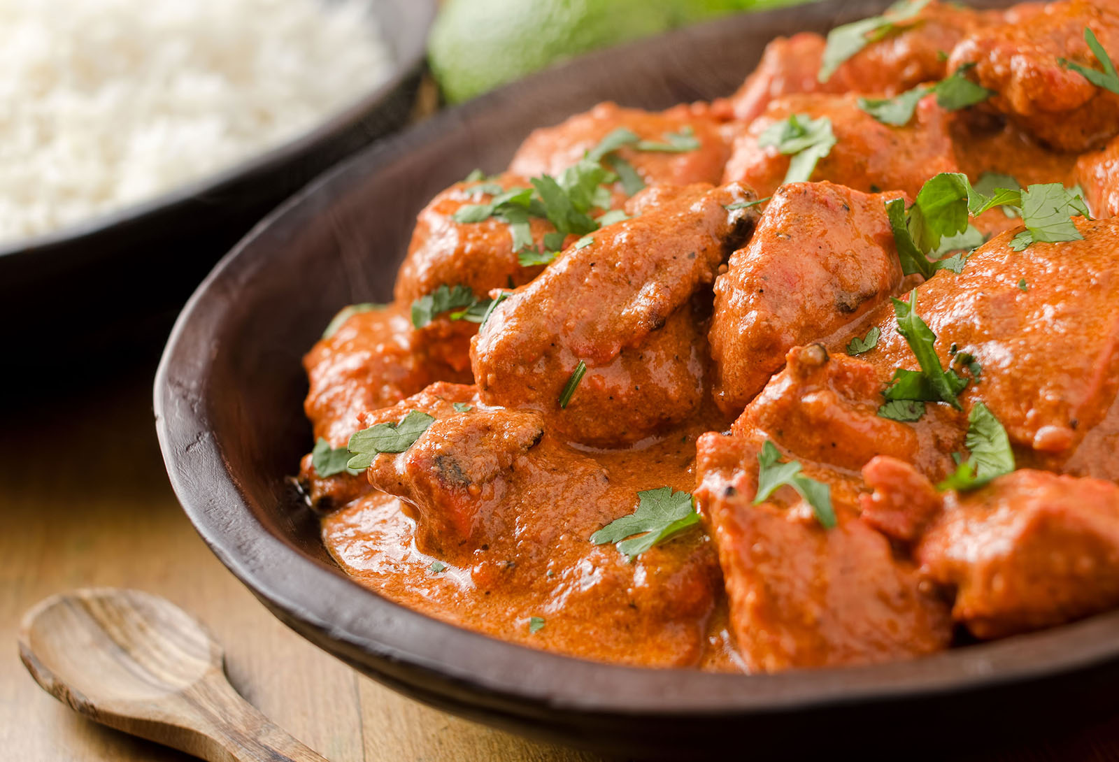 Butter chicken curry with basmati rice and limes.